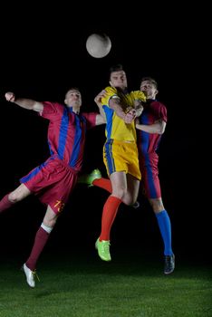 soccer player doing kick with ball on football stadium  field  isolated on black background