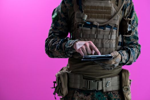 soldier using tablet computer hands closeup pnk background