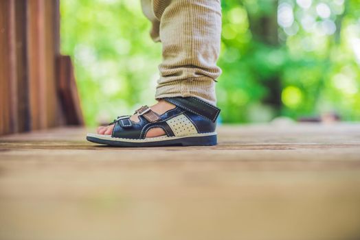 children's orthopedic shoes on the boy's feet.