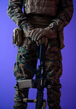 american  marine corps special operations modern warfare soldier with fire arm weapon and protective army tactical gear ready for battle on purple background