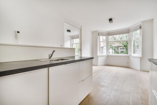 The interior of the kitchen area with a snow-white kitchen set