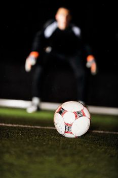 soccer football goal keeper in night with falling rain