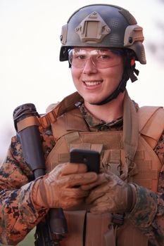 soldier using smart phone to contact family or girlfriend communication and nostalgia concept
