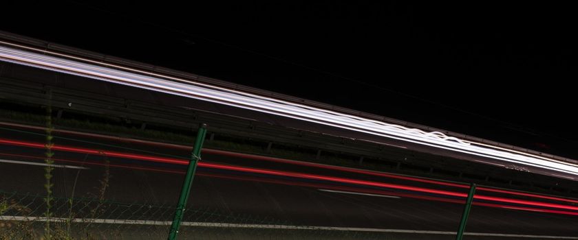 abstract background with car light trails in night on fast highway