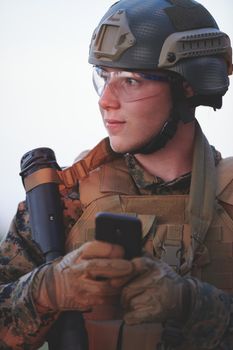 soldier using smart phone to contact family or girlfriend communication and nostalgia concept