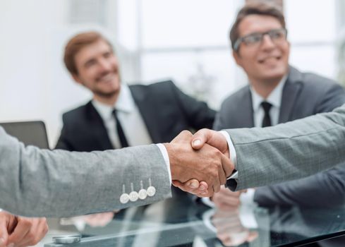 close up. handshake of business people on a blurred office background. concept of partnership