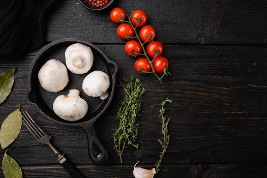 Raw mushrooms champignons set, on black wooden table background, top view flat lay, with copy space for text