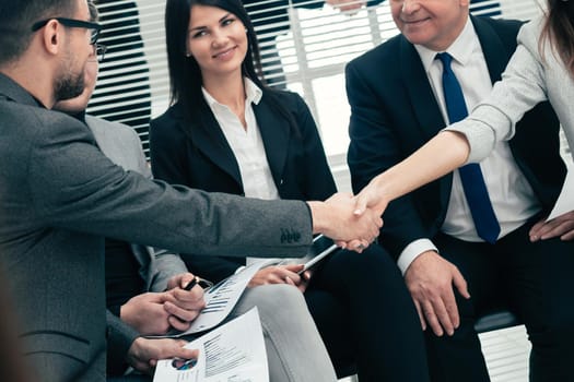 business colleagues shaking hands with each other. the concept of teamwork