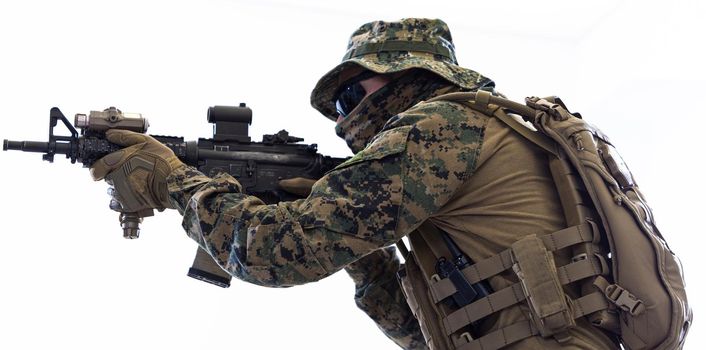 modern warfare american marines soldier aiming  in combat position and searching for target isolated on white background