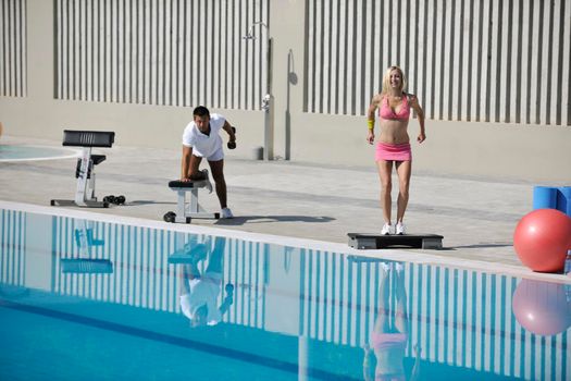 young couple exercise aerobic and fitness at early morning at swimming pool