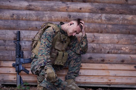 upset  soldier has psychological problems holding his head