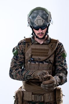 closeup of modern warfare soldier hands putting protective battle gloves white background