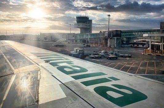 Catania, Italy, July 2021; The Alitalia logo on the wing of an airplane departing at the airport. Alitalia is the Italian national airline that will close the service on 14 October 2021