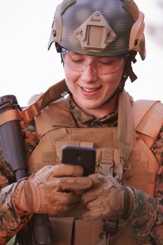soldier using smart phone to contact family or girlfriend communication and nostalgia concept