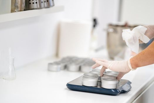 filling molds with hand-made natural organic cosmetics.
