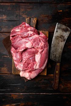 A large piece of raw meat set, on old dark wooden table background, top view flat lay, with copy space for text
