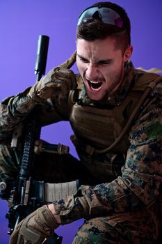 soldier preparing tactical and communication gear for action battle purple background