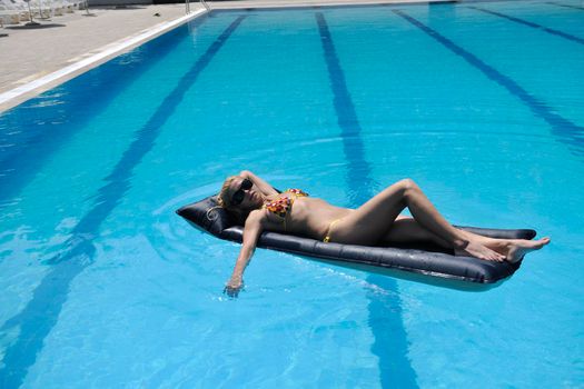 beautiful young woman relax and have fun at swimming pool