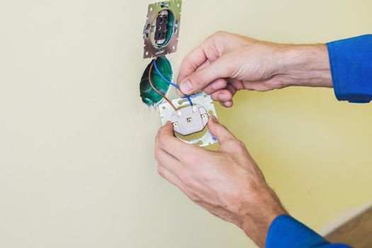 Electrician Installing Socket In New House. Electrician in the house