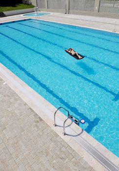 beautiful young woman relax and have fun at swimming pool