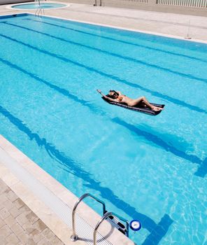 beautiful young woman relax and have fun at swimming pool