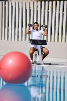 young healthy athlete man exercise at poolside