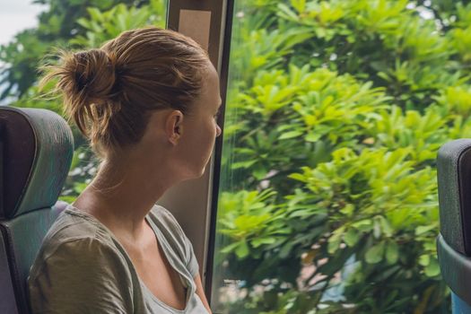 beautiful young woman taking bus to work.