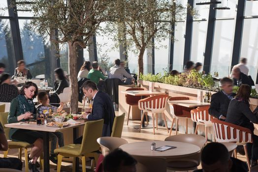 Young parents enjoying lunch time with their children at a luxury restaurant