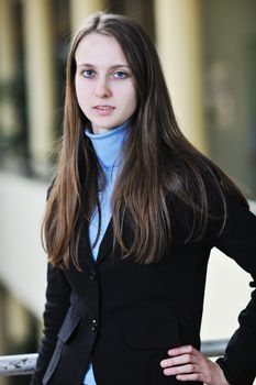 happy young student girl possing at university campus and reopresenting education concept