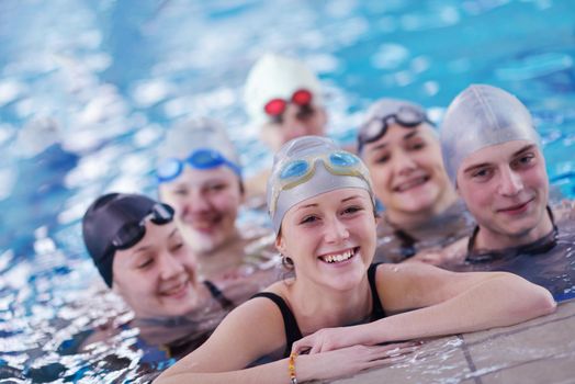 happy teen  group  at swimming pool class  learning to swim and have fun