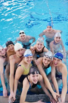 happy teen  group  at swimming pool class  learning to swim and have fun