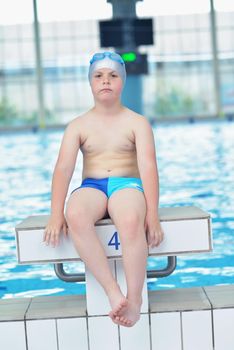 happy little child portrait on swimming school classes and recreation at indoor pool