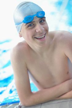 happy little child portrait on swimming school classes and recreation at indoor pool