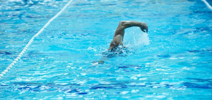 young healthy with muscular body man swim on swimming pool and representing healthy and recreation concept