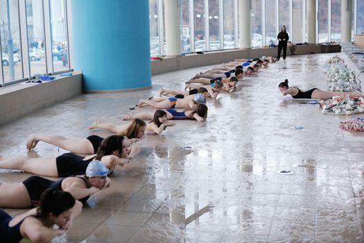 happy children kids group  at swimming pool class  learning to swim