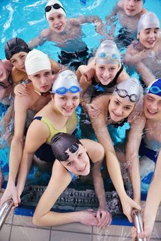 happy teen  group  at swimming pool class  learning to swim and have fun