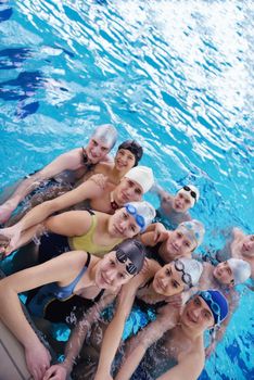 happy teen  group  at swimming pool class  learning to swim and have fun