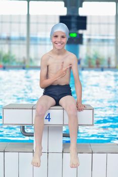 happy little child portrait on swimming school classes and recreation at indoor pool