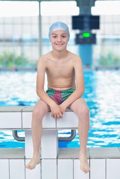 happy little child portrait on swimming school classes and recreation at indoor pool