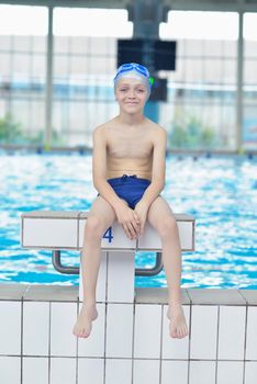 happy little child portrait on swimming school classes and recreation at indoor pool