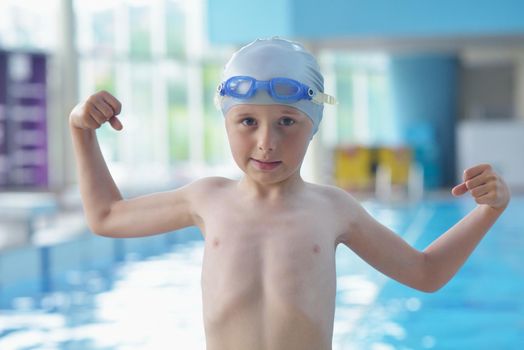 happy little child portrait on swimming school classes and recreation at indoor pool