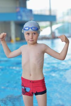 happy little child portrait on swimming school classes and recreation at indoor pool