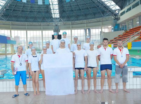 portrait group of happy kids children  at swimming pool school with empty white flag