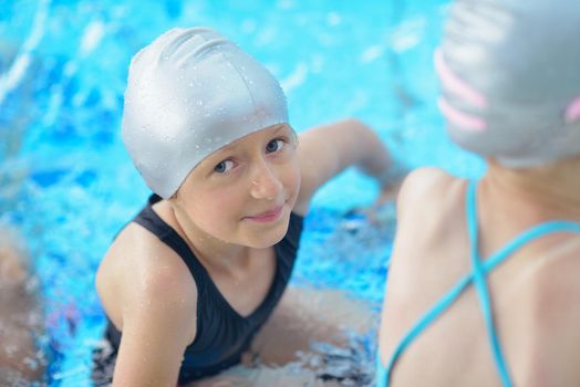 happy little child portrait on swimming school classes and recreation at indoor pool