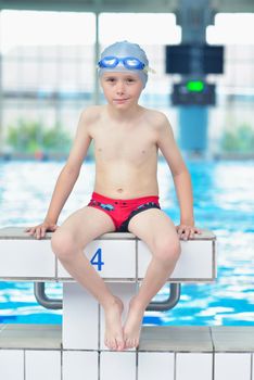 happy little child portrait on swimming school classes and recreation at indoor pool