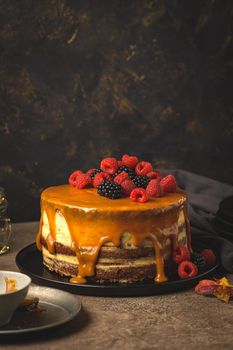 Delicious caramel cake with blackberries and raspberries.