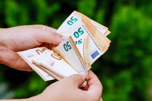 Man hands counting us euro banknotes. Counting money.