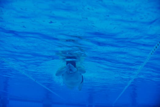 sport swimming pool  underwater with blue color and swimmers