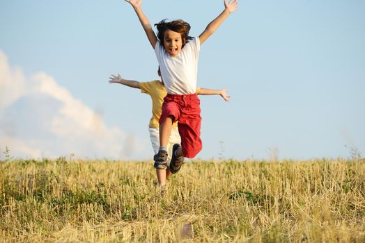 Happy children running on beautiful field