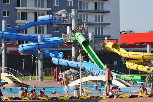 happy child have fun on water slike on outdoor swimming pool 